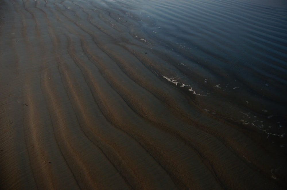 a sandy beach with ripples in the sand