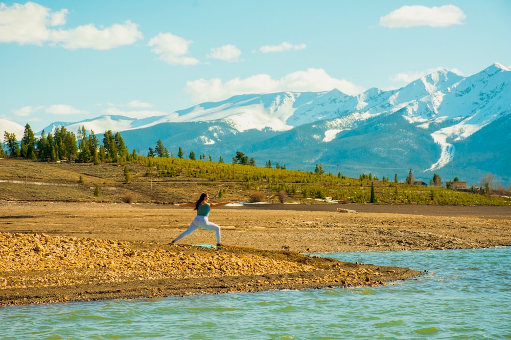 woman doing yoga near river