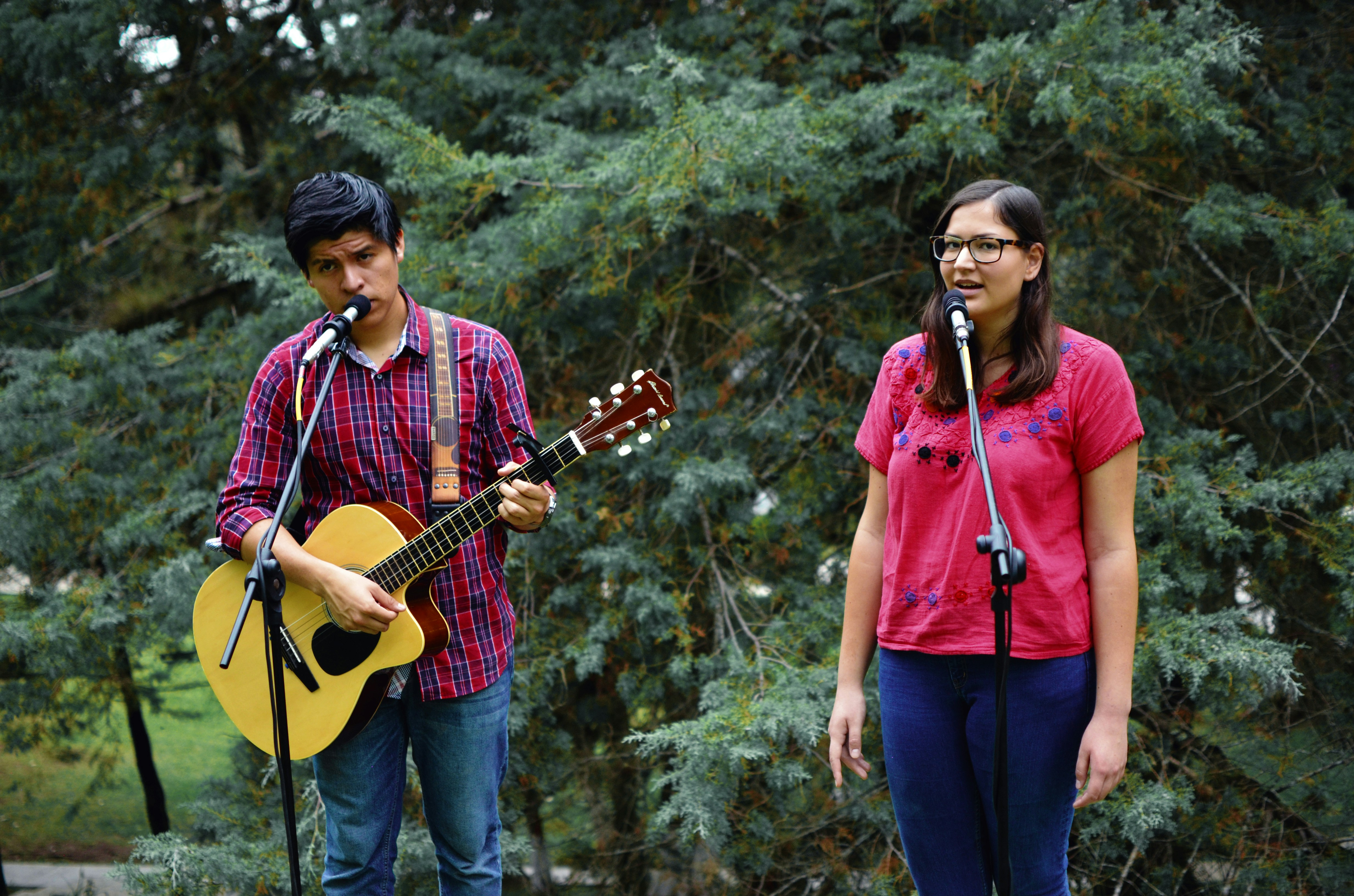 man and woman near tree pueblo revival teams background