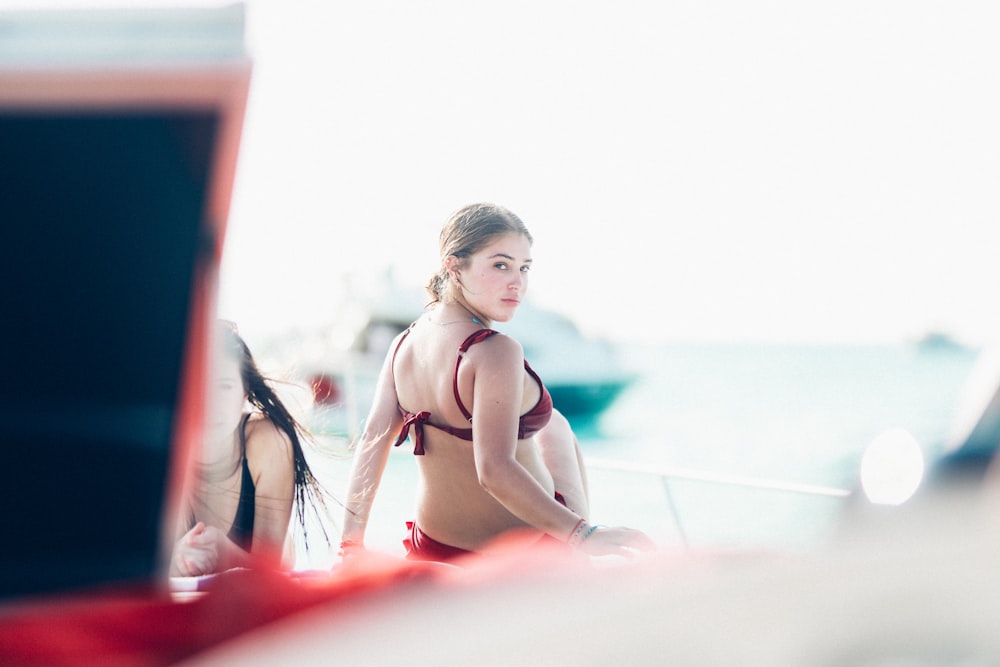 woman wearing red bikini looking over her right shoulder