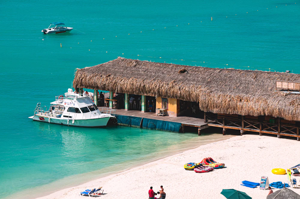 Overwater bungalow and boat at a tropical resort