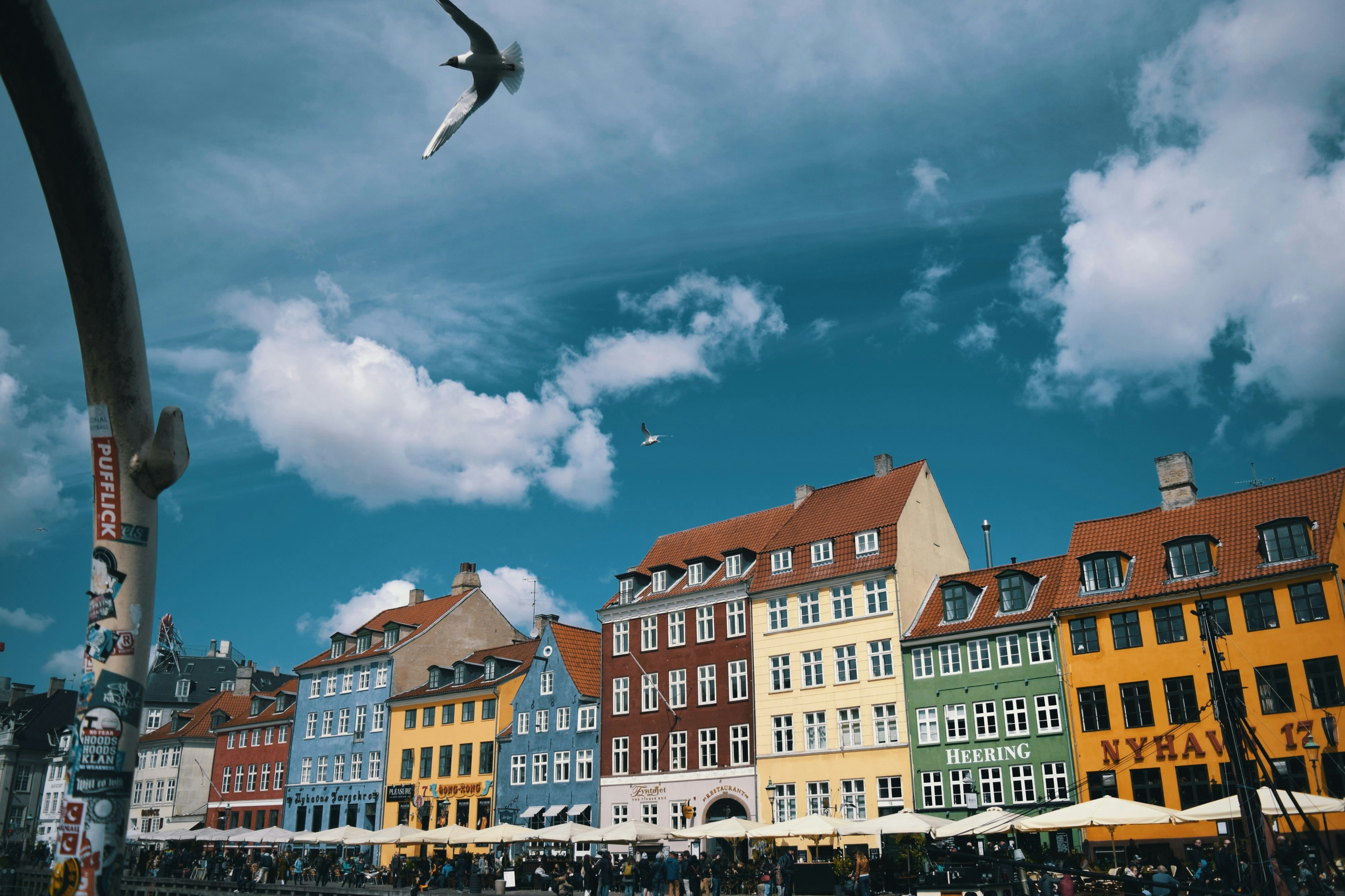 Exhibition hall with drones and attendees at a drone industry trade show in Denmark.
