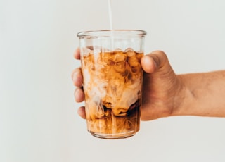 clear drinking glass with brown liquid