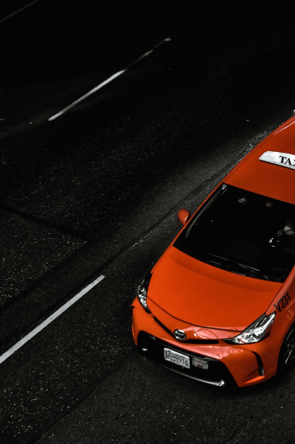 red Toyota taxi on the street