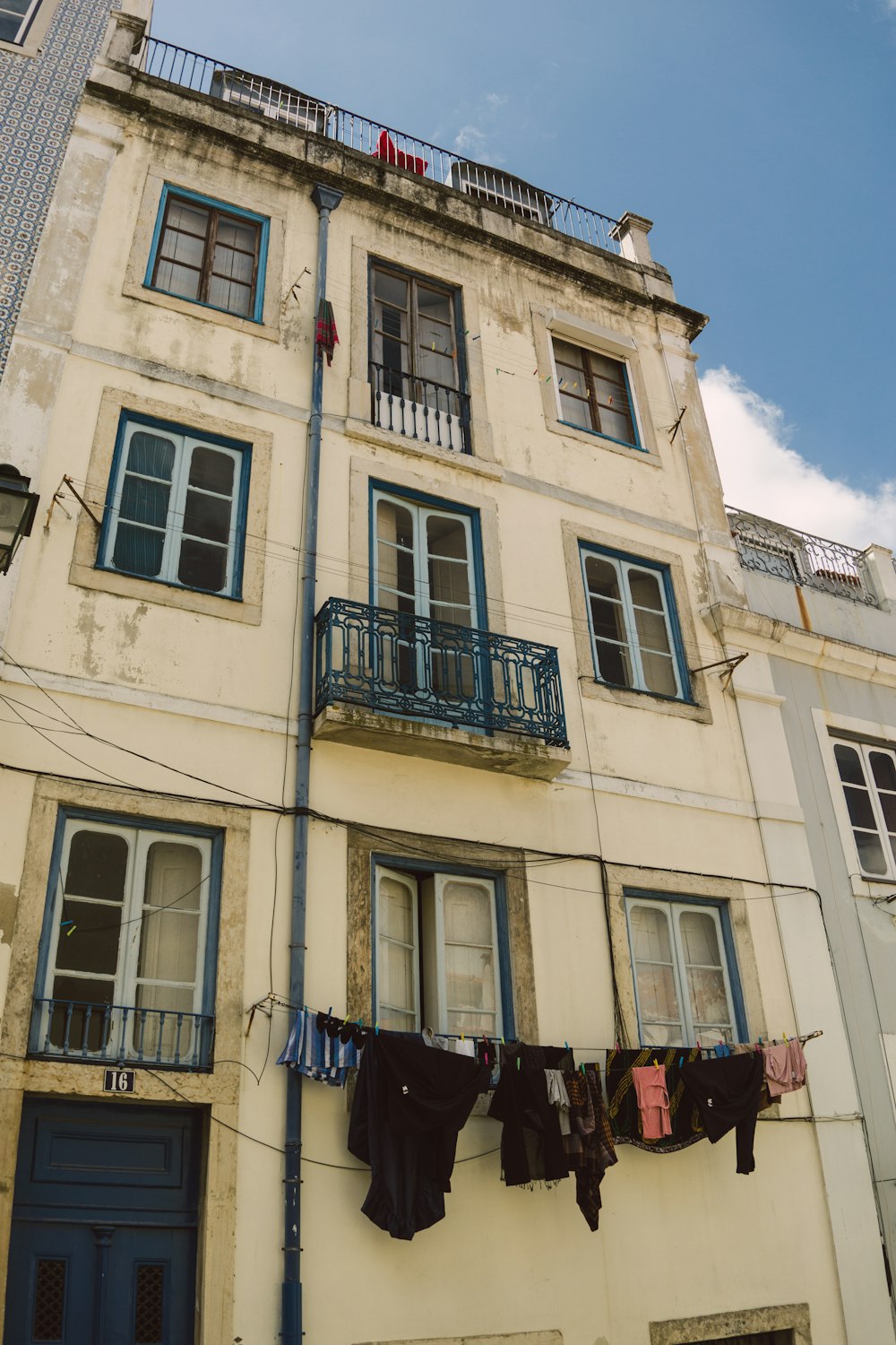 clothes hanging by the window of a concrete multi-storey building