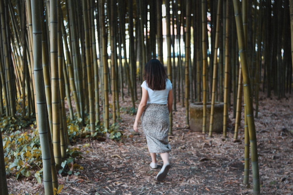 woman walking in bamboo grasses