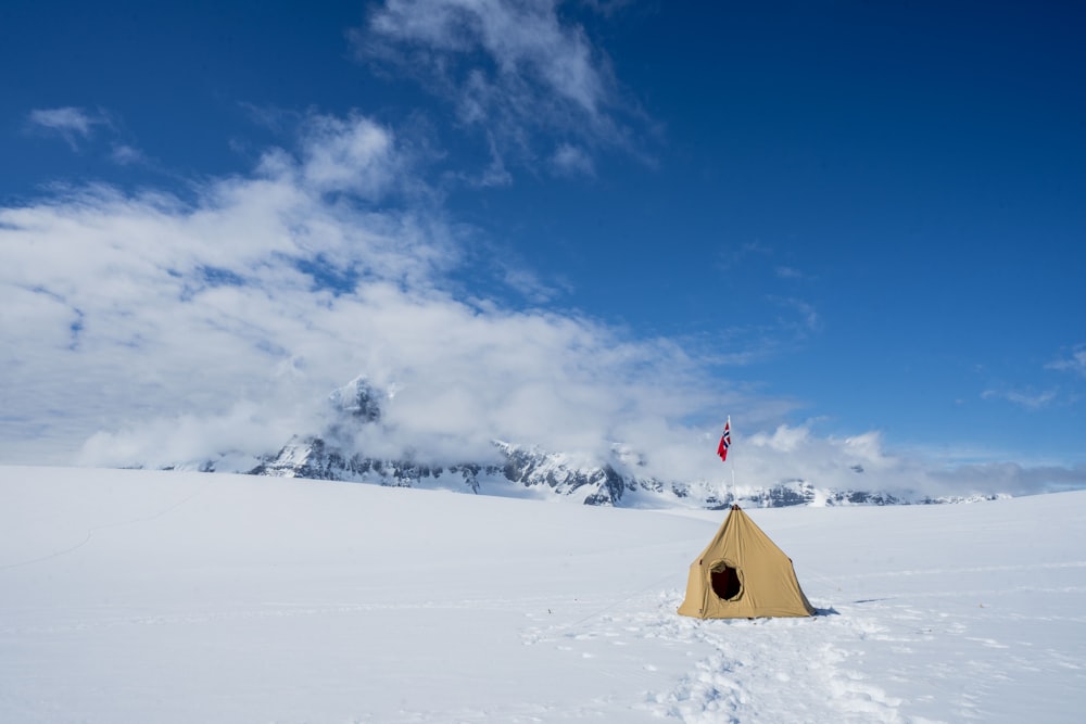 brown tent at the snow during daytime