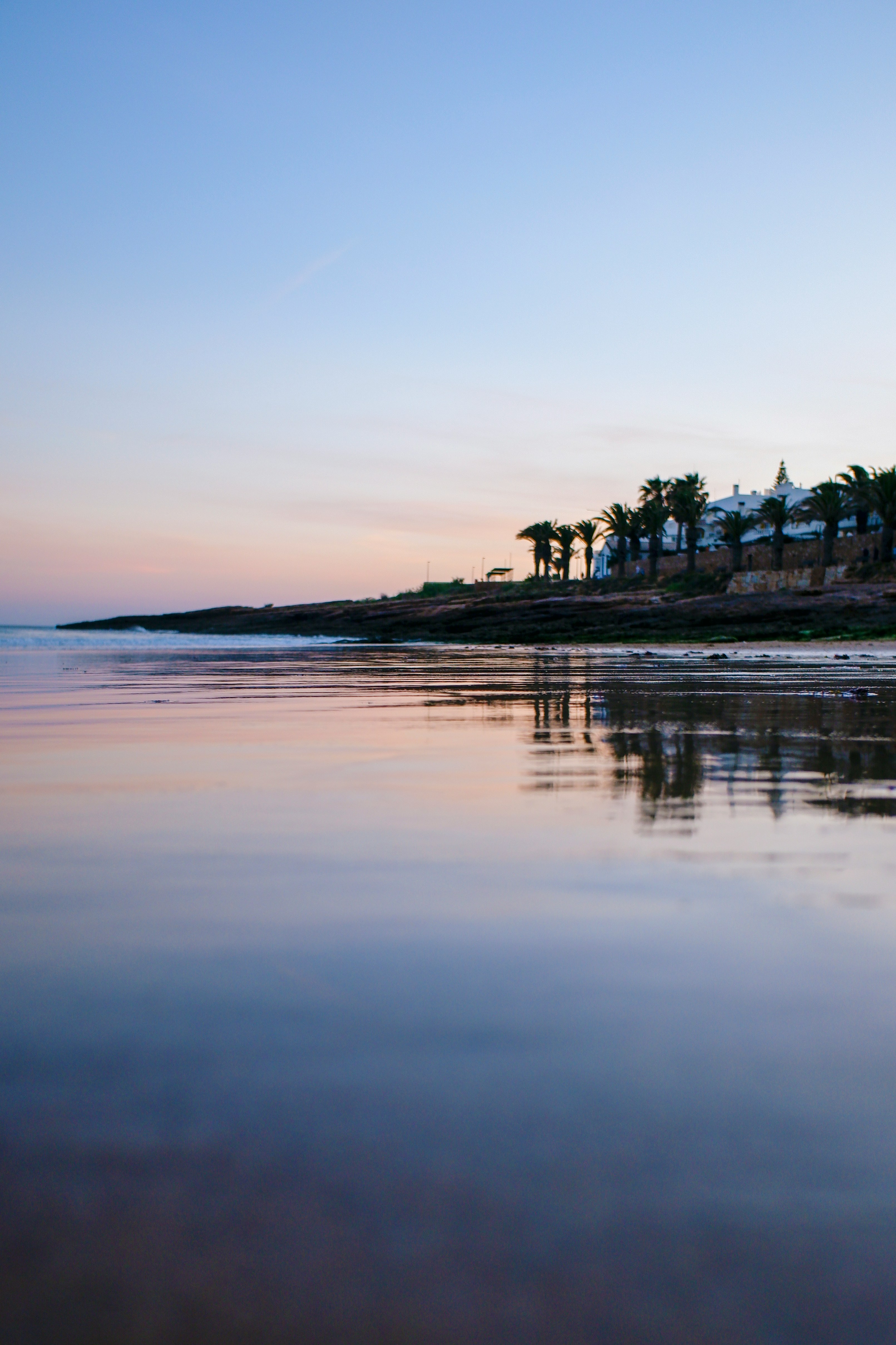 Pristine waters at Mirror Beach with hills in the background