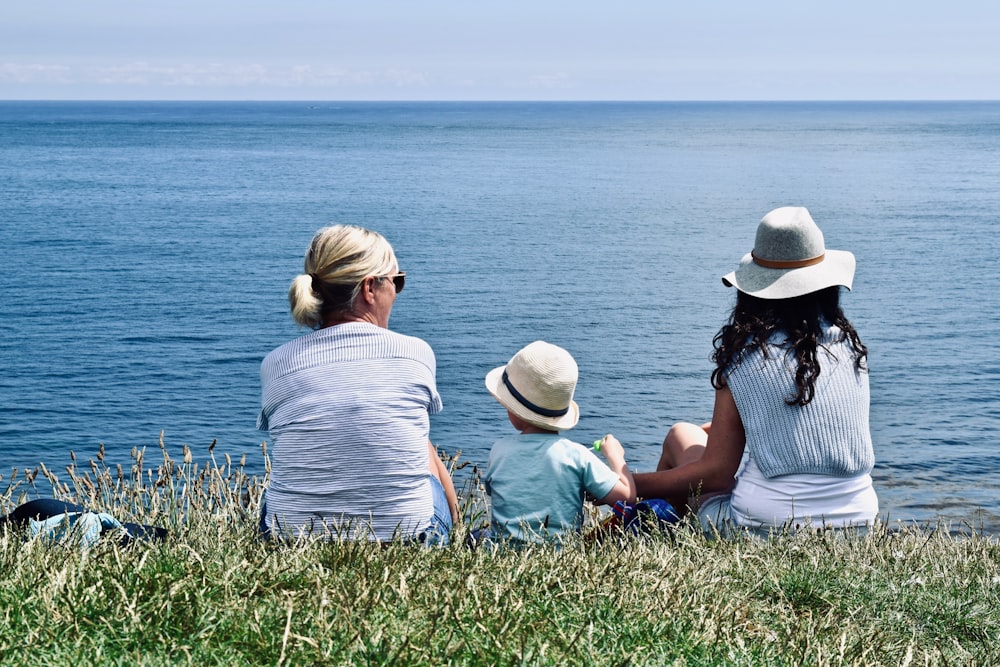 women and child near ocean