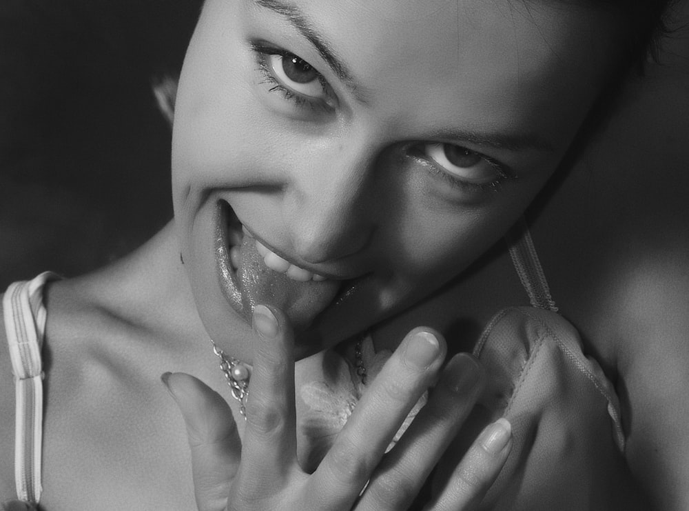 woman putting finger near tongue