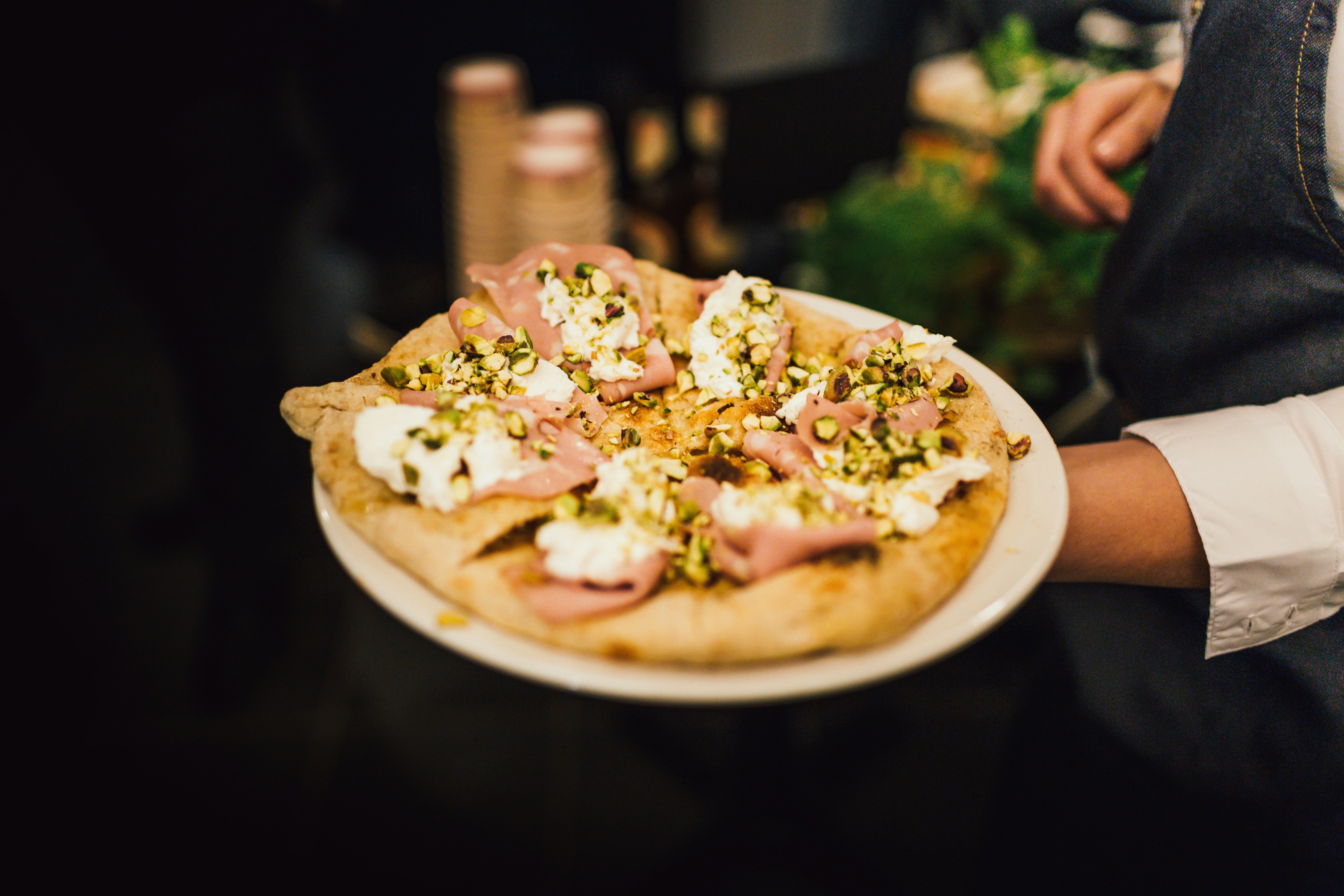 person holding plate of pizza