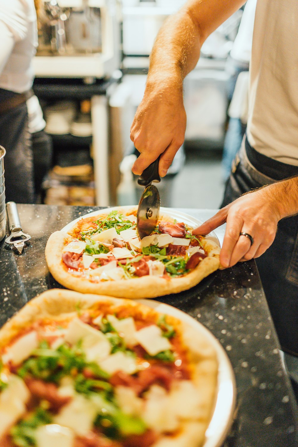 man cutting pizza