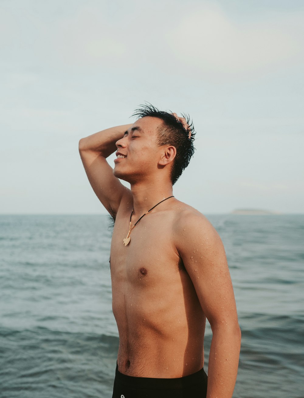 man wearing black shorts near the ocean