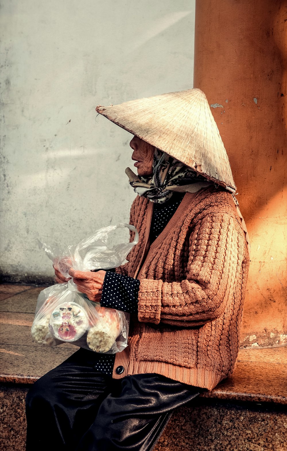 woman holding plastic bag with foods during daytime