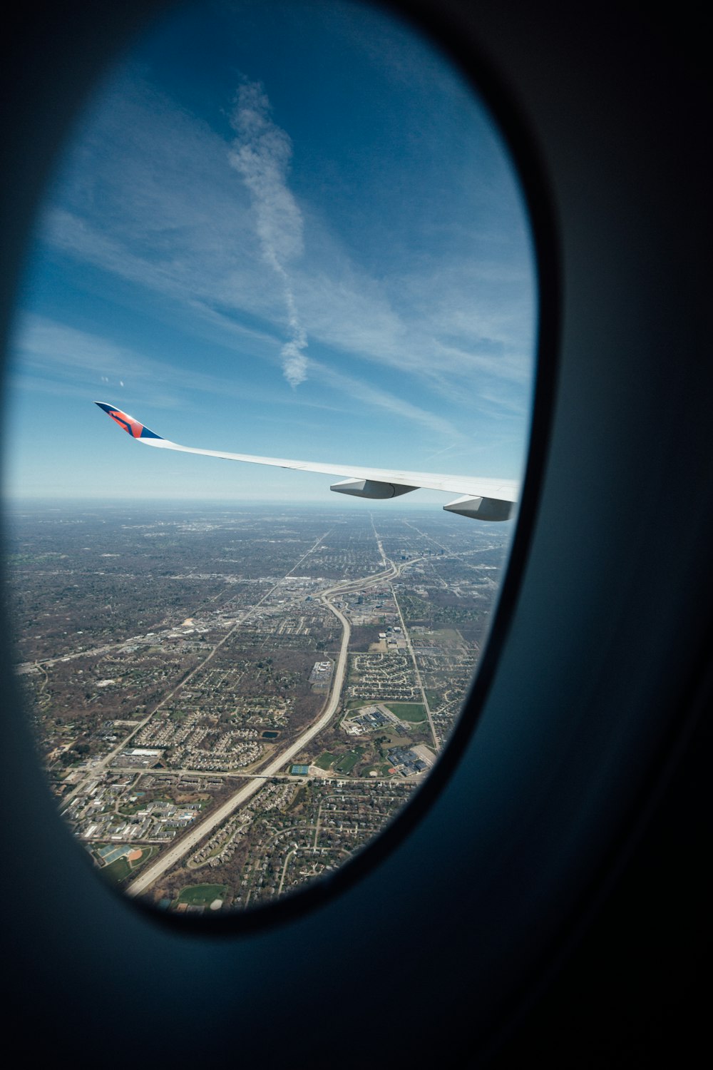 airplane wings under white clouds during daytime