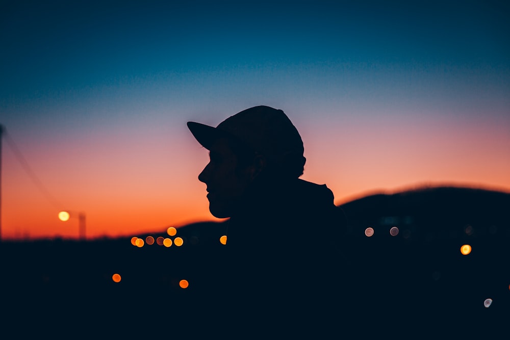 silhouette photo of woman near mountain