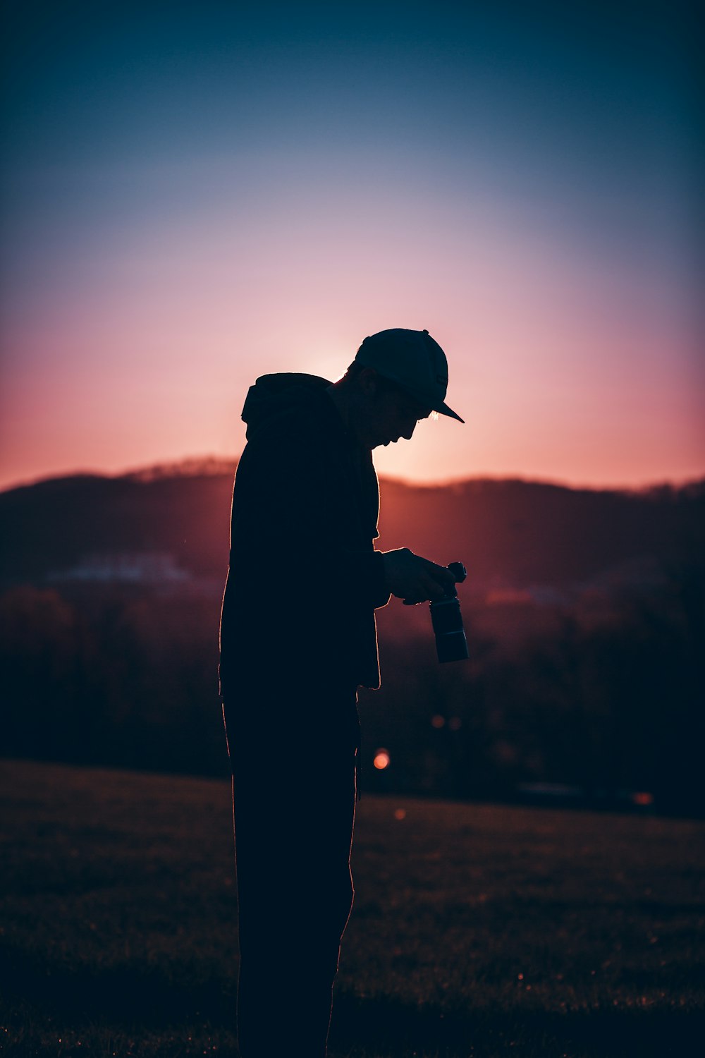 silhouette of man holding camera