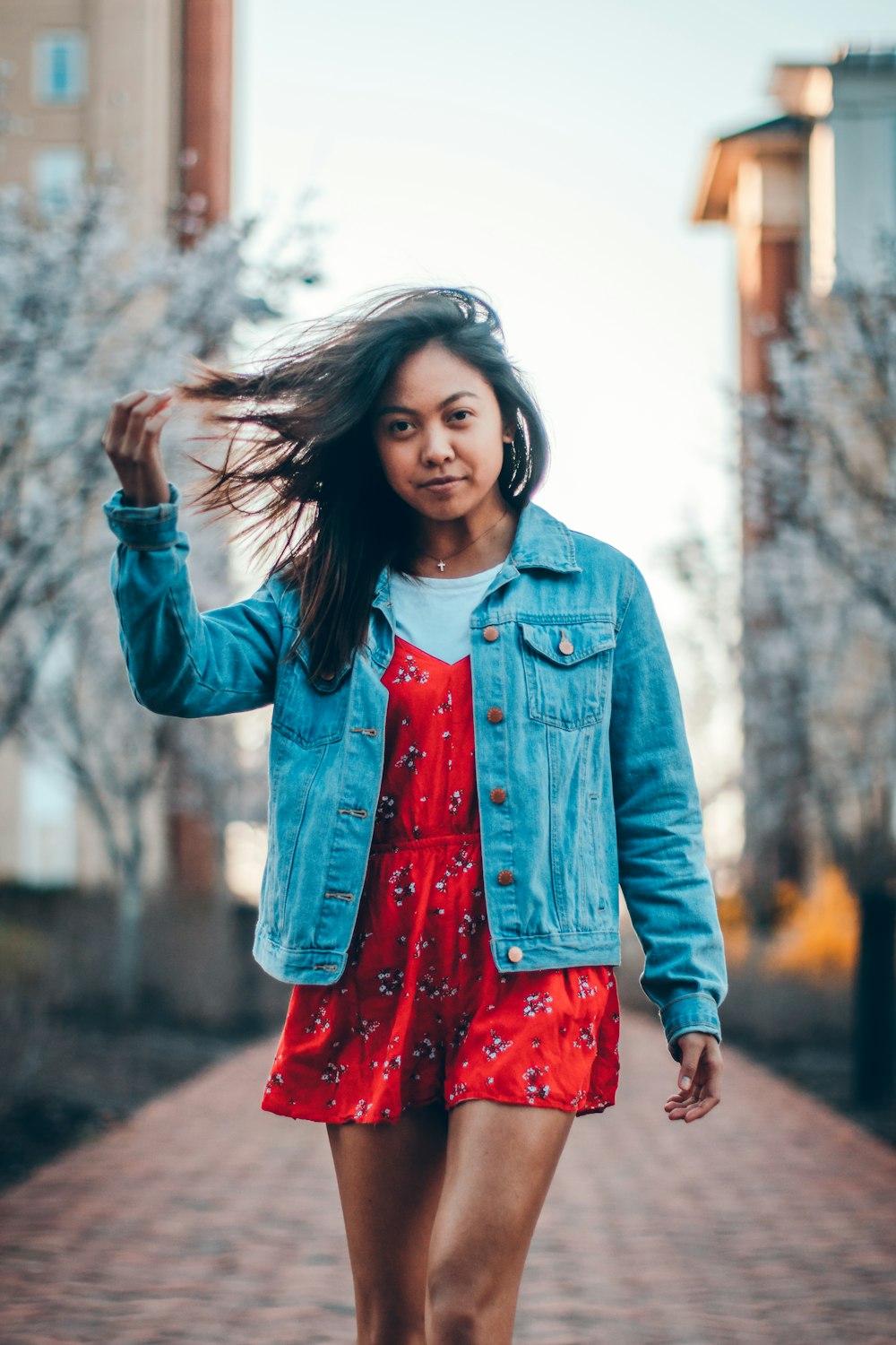 Standing woman wearing red dress and blue denim jacket photo – Free Flowers  Image on Unsplash