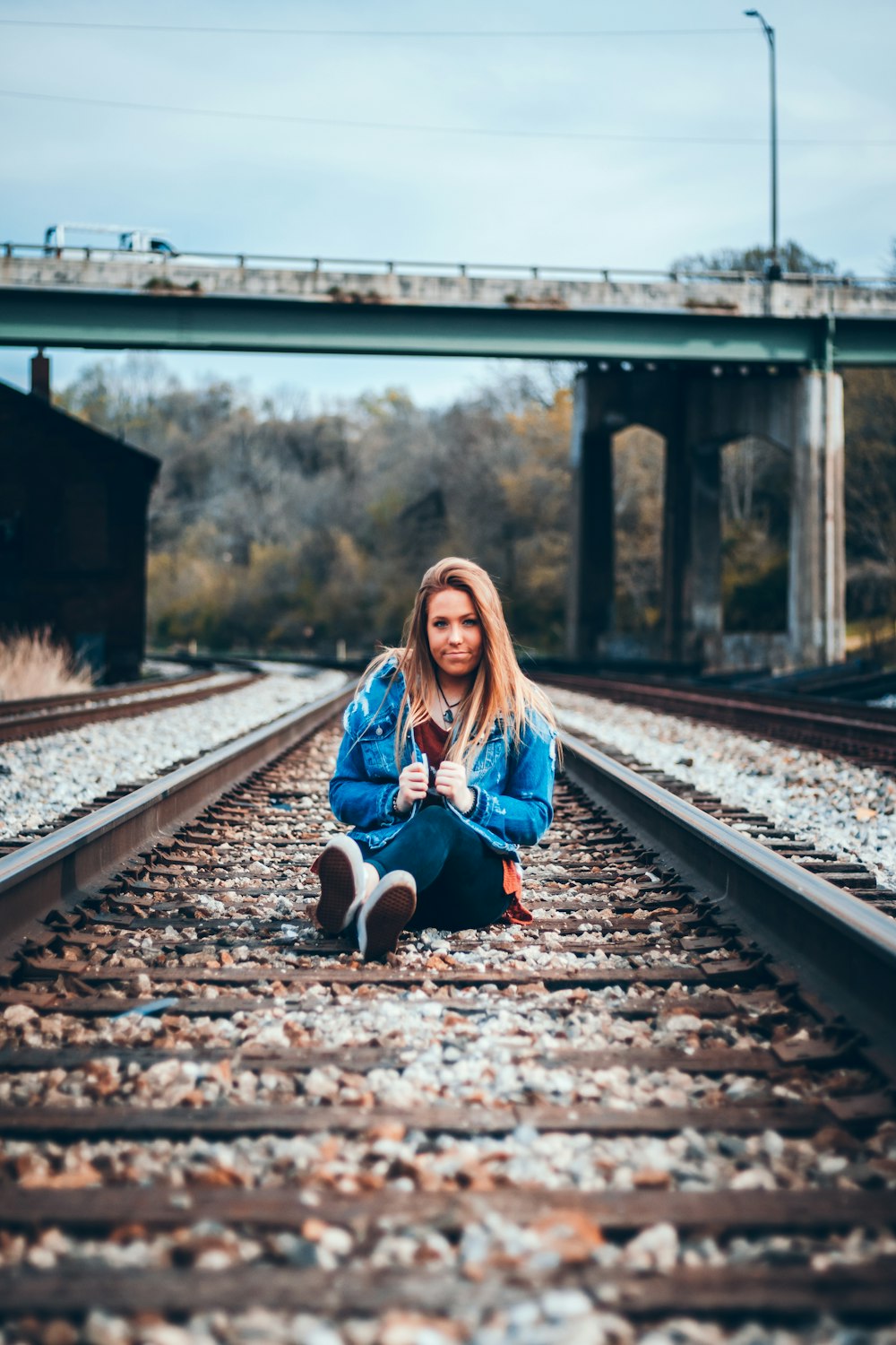 woman sitting on trail railway