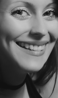 A close-up of a smiling client during a portrait session, showcasing natural expressions.