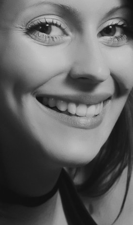 A close-up of a smiling client during a portrait session, showcasing natural expressions.