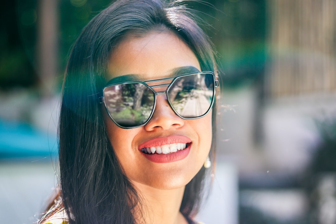 woman wearing black-framed sunglasses
