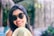 smiling woman wearing black sunglasses taking selfie
