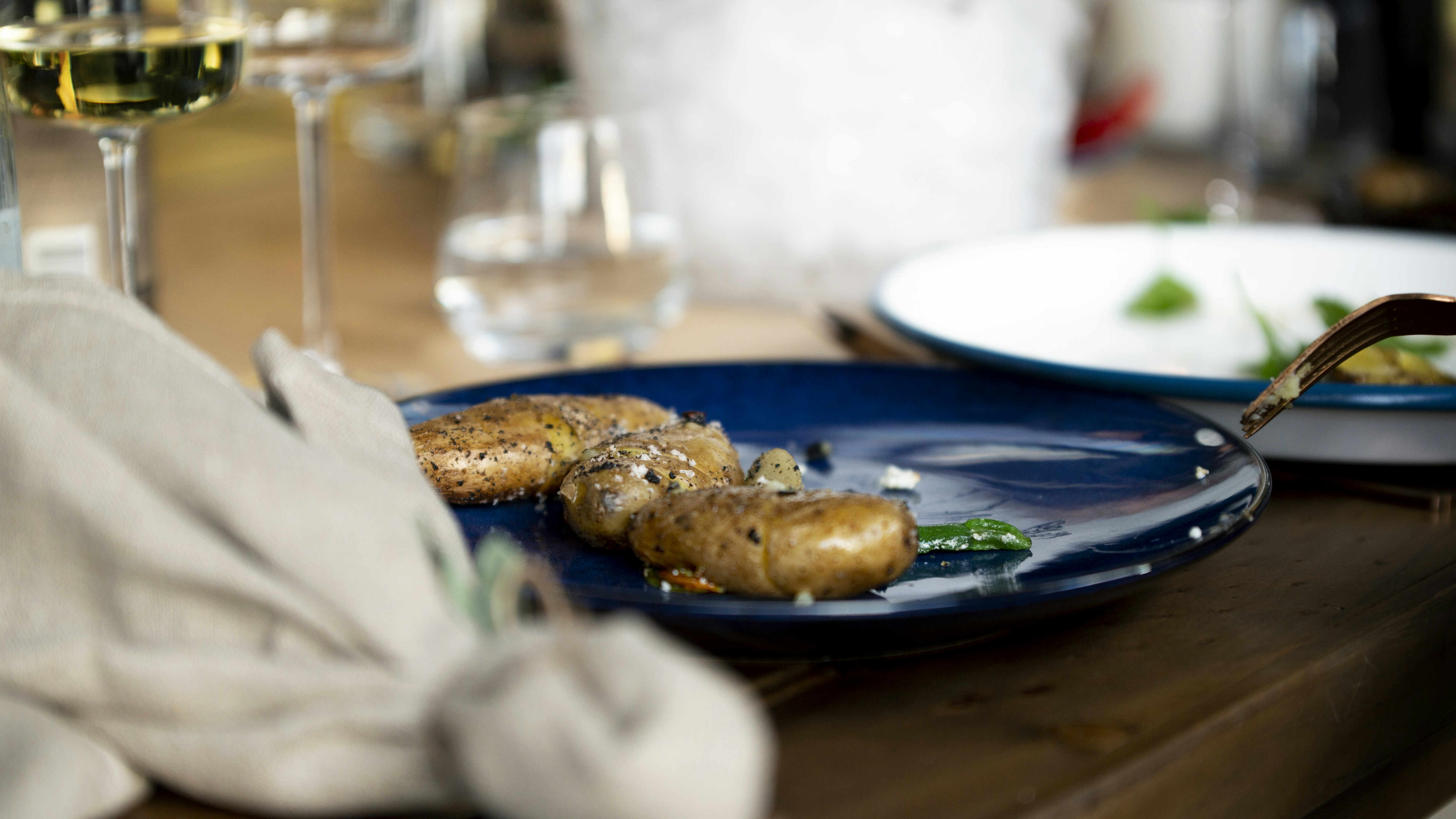 Plated dish on a navy plate at a restaurant table