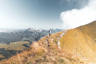 man standing on mountain during daytime