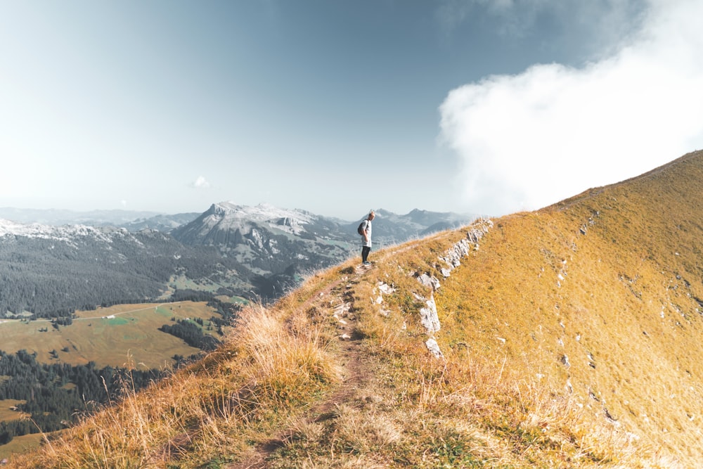 man standing on mountain during daytime