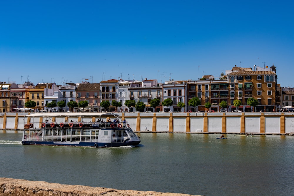 boat on body of water near buildings during daytime