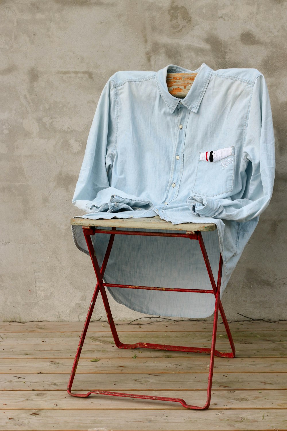 blue dress shirt on chair