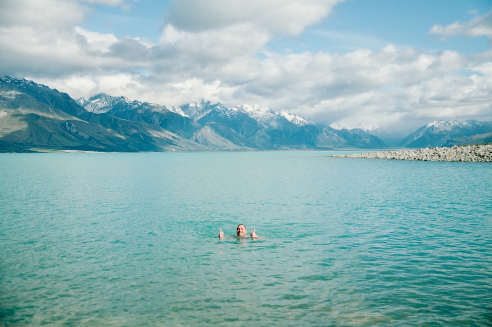 man dipping in ocean