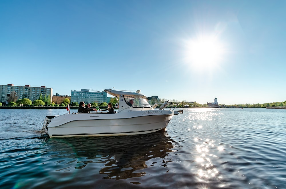 people riding white bowrider boat in the sea