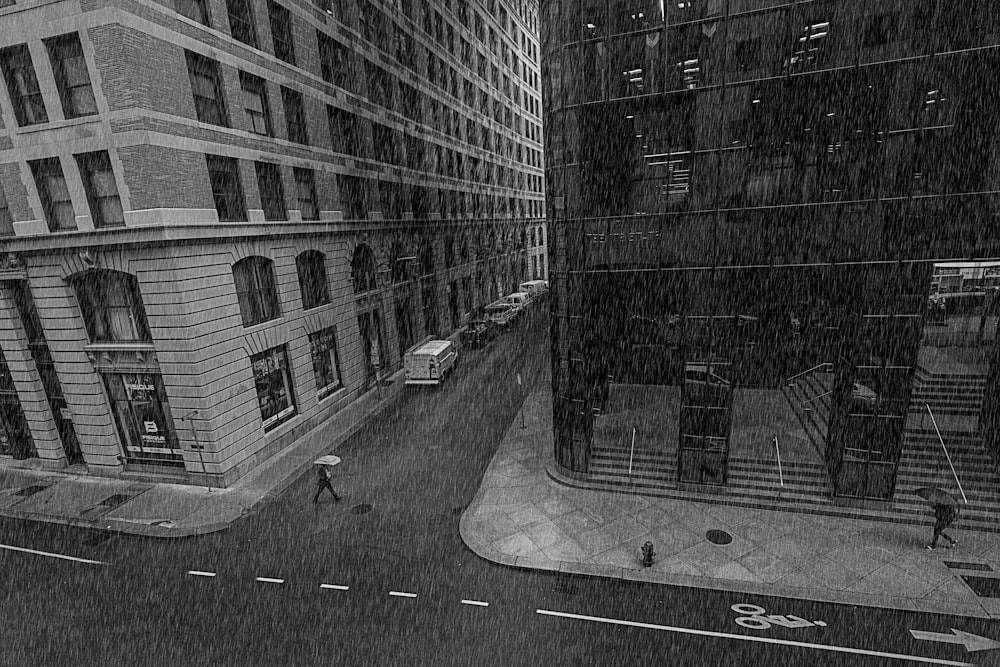 grayscale photo of street between buildings