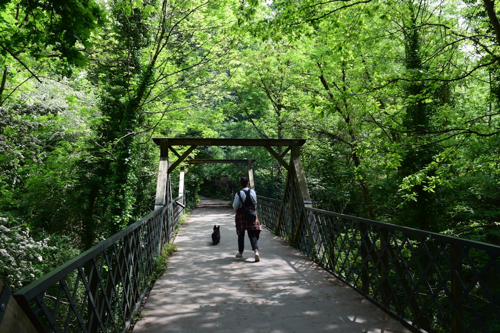 man walking in bridge during daytime