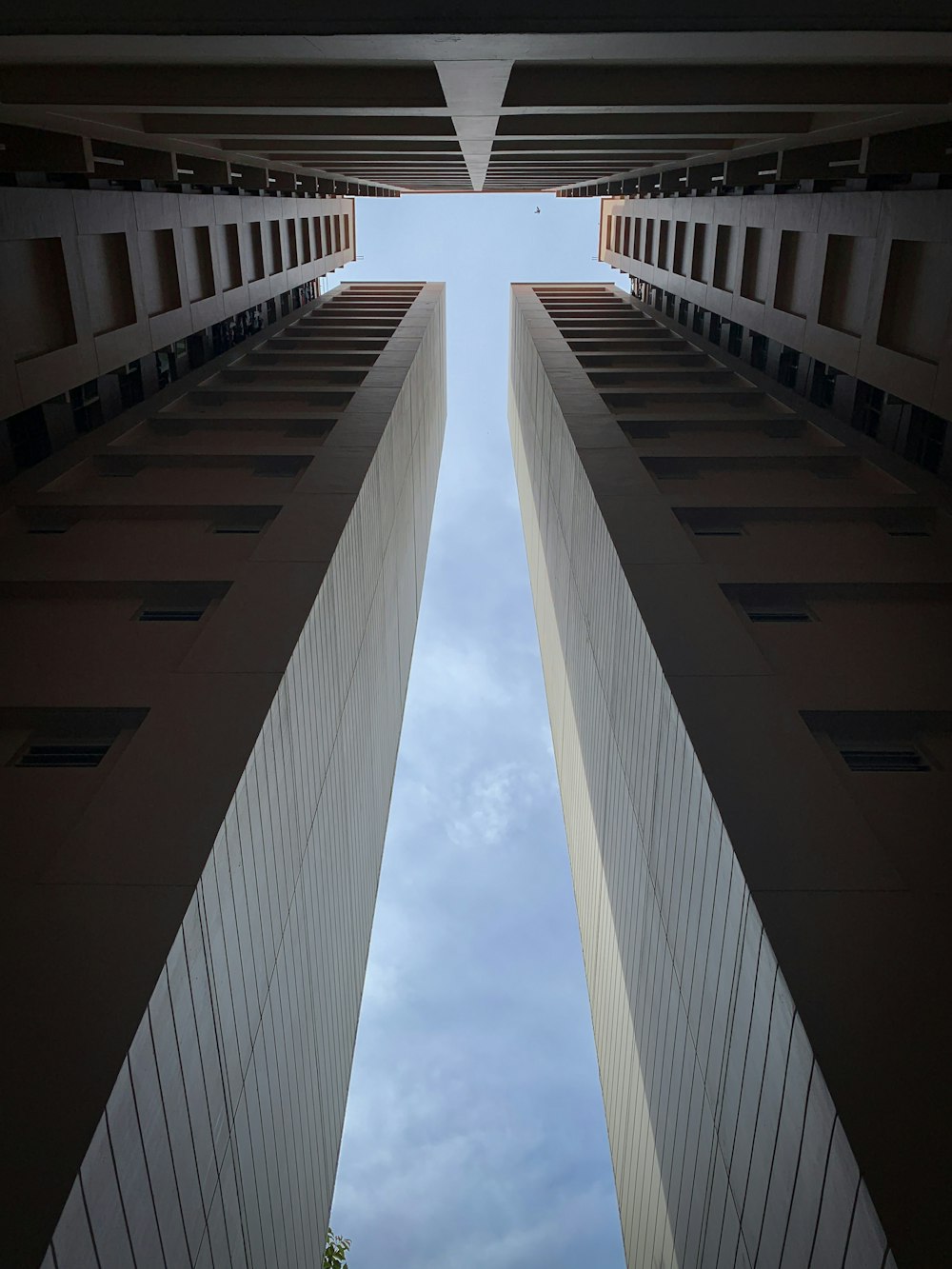 low-angle photo of high-rise buildings under blue sky