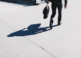 A child happily carrying a bright school bag down a sunny sidewalk.