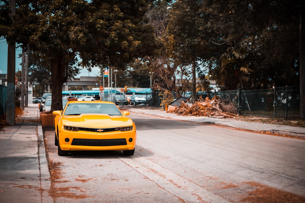 yellow vehicle near tree