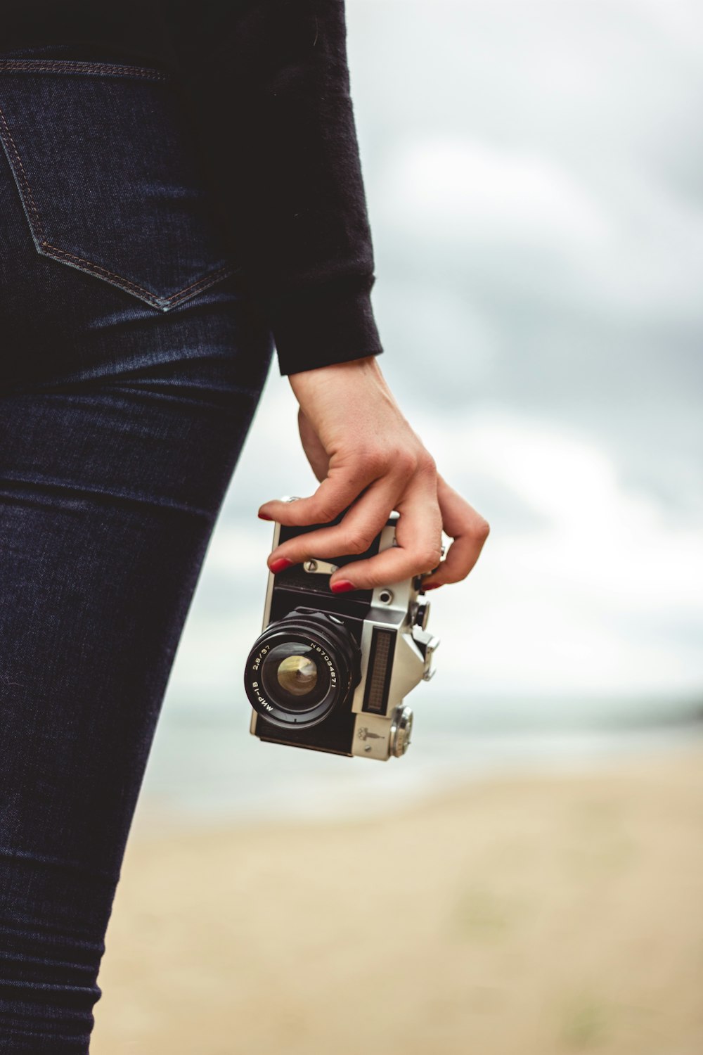 person holding black and grey camera