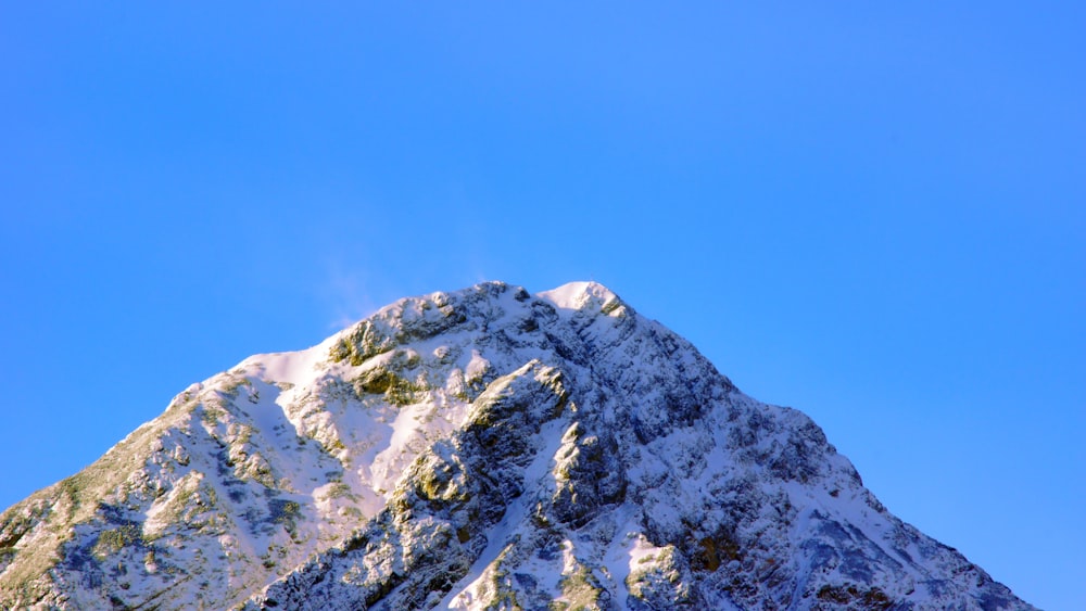 snow-capped mountain under blue sky