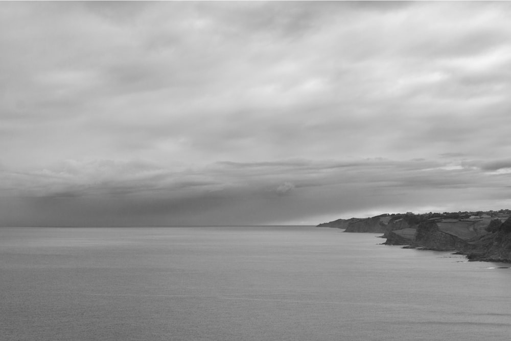 calm sea under gray clouds