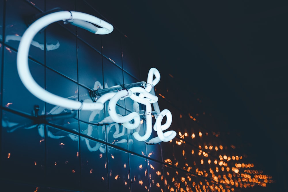 a close up of a neon sign on the side of a building