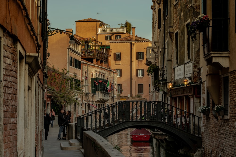 arch bridge over canal between houses