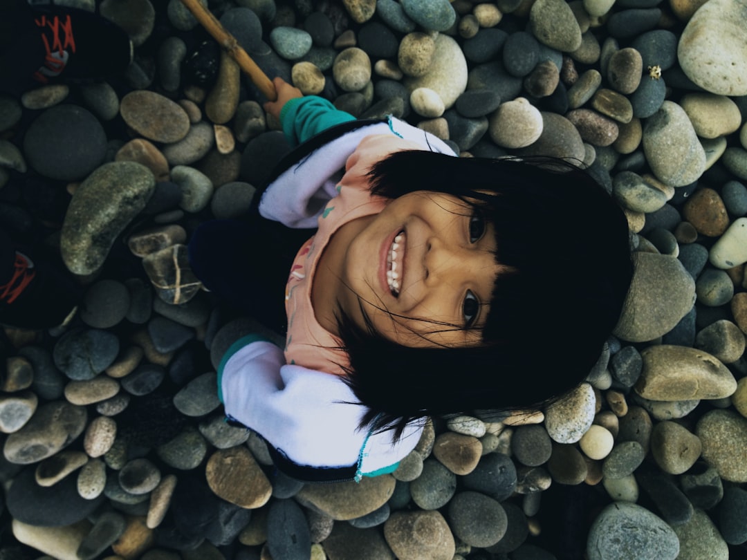 girl in orange shirt standing and smiling