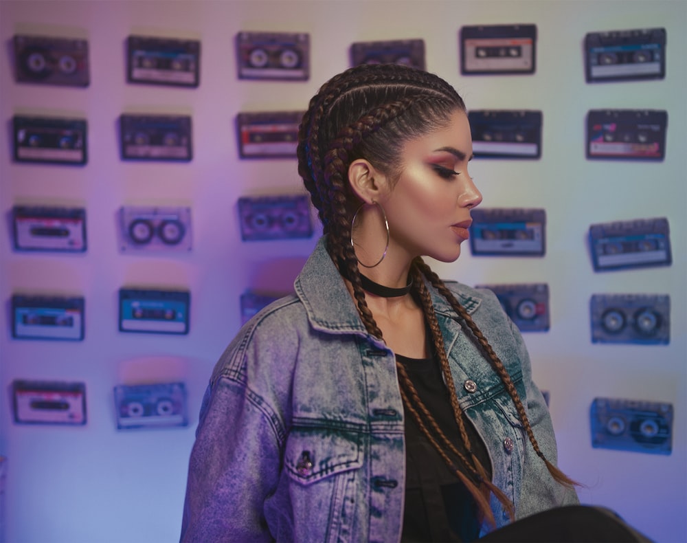 man with braided hair and blue denim jacket