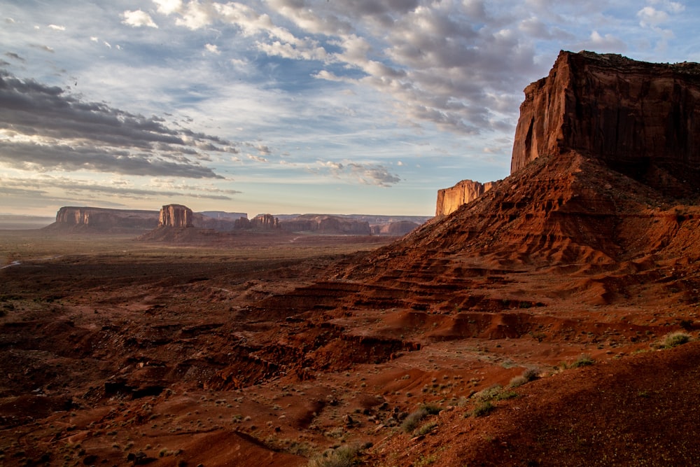 rock mountain under dramatic clouds during daytime