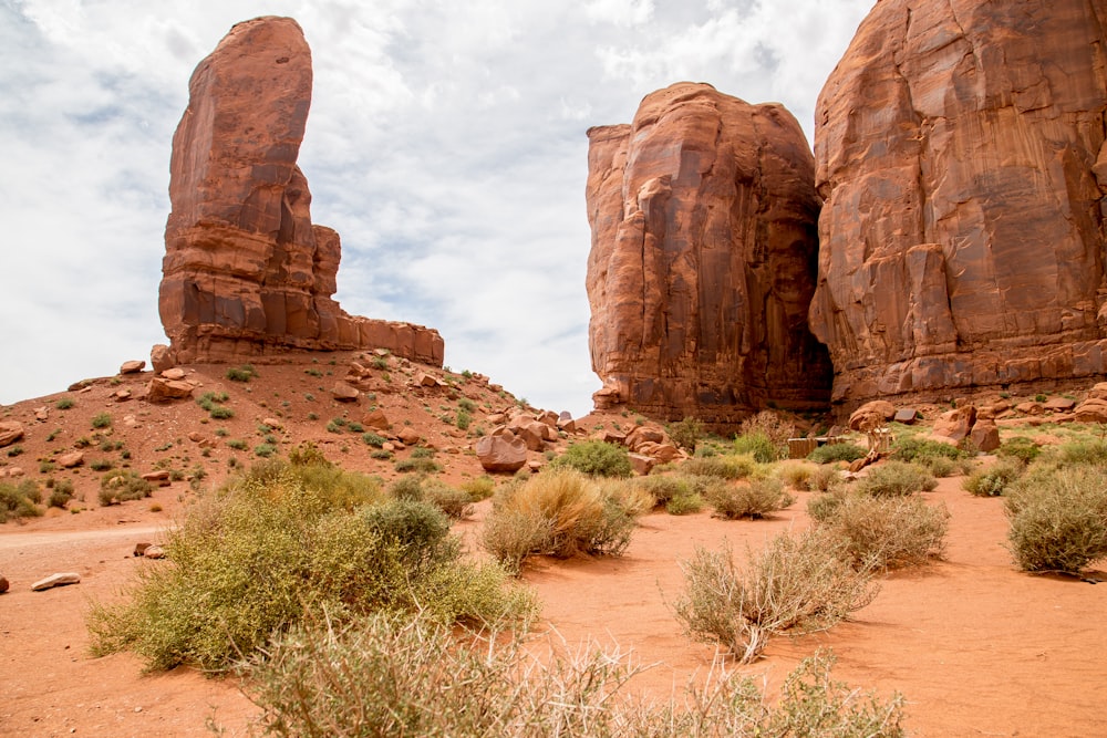 brown rock formation under white clouds