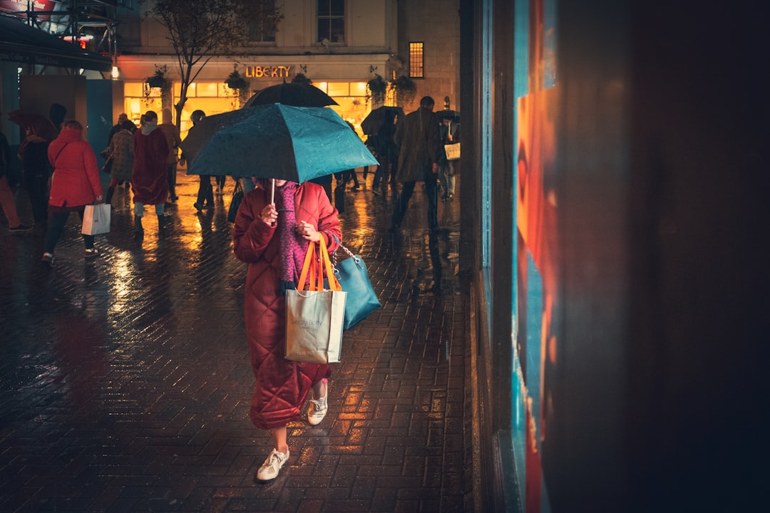 person standing under umbrella at night