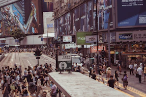 An urban street scene bustling with people, accompanied by a label describing the city and cultural highlights.